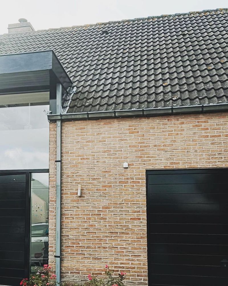 Gevel met geschilderde garagepoort en strakke afwerking