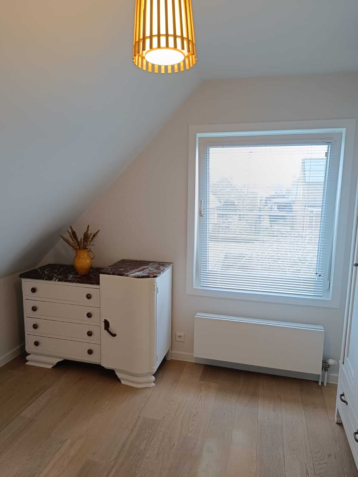 Slaapkamer met strak geschilderde lichte wanden
